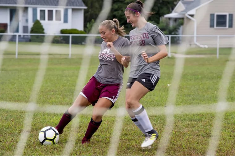 Riverside High School  senior striker Hailey Russell (left) goes up against her twin sister, Hannah, at practice.