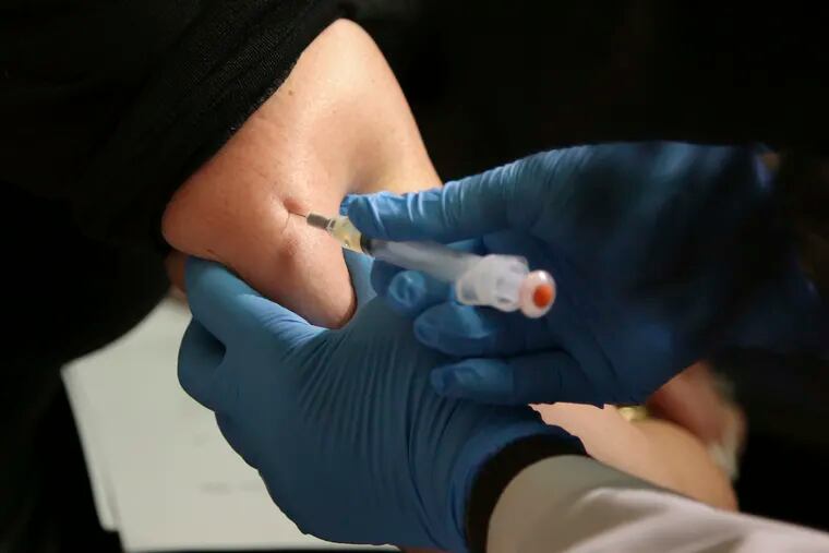 A woman receives a measles, mumps, and rubella vaccine at the Rockland County Health Department in Pomona, N.Y.