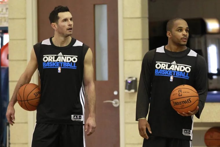 The Orlando Magic’s J.J. Redick (left) and Jameer Nelson listen to head coach Jacque Vaughn during training camp in October 2012.