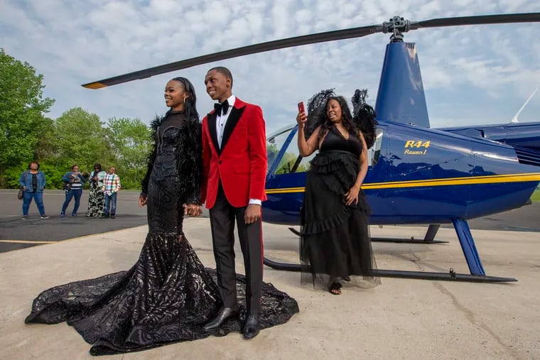 Saudia Shuler (right) films Nieme Brooker with his date, Tiana Johnson, in this James Bond-style prom send-off in May 2018.