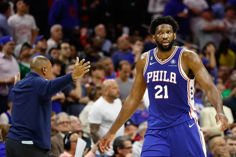 Sixers center Joel Embiid walks to the Sixers bench after committing a third quarter foul past head coach Doc Rivers against the Boston Celtics during Game 6.