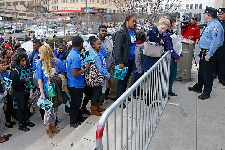 A long line of students, teachers, parents and school administrators wait to enter the Board of Education building on Broad Street to attend the School Reform Commission meeting.
