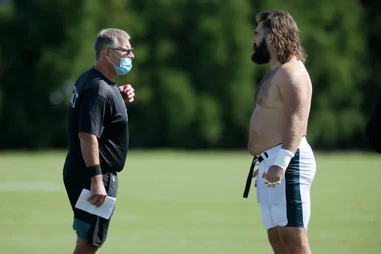 Eagles offensive line coach Jeff Stoutland (left) talks with center Jason Kelce during training camp at the NovaCare Complex in South Philadelphia on Wednesday, Aug. 26, 2020.