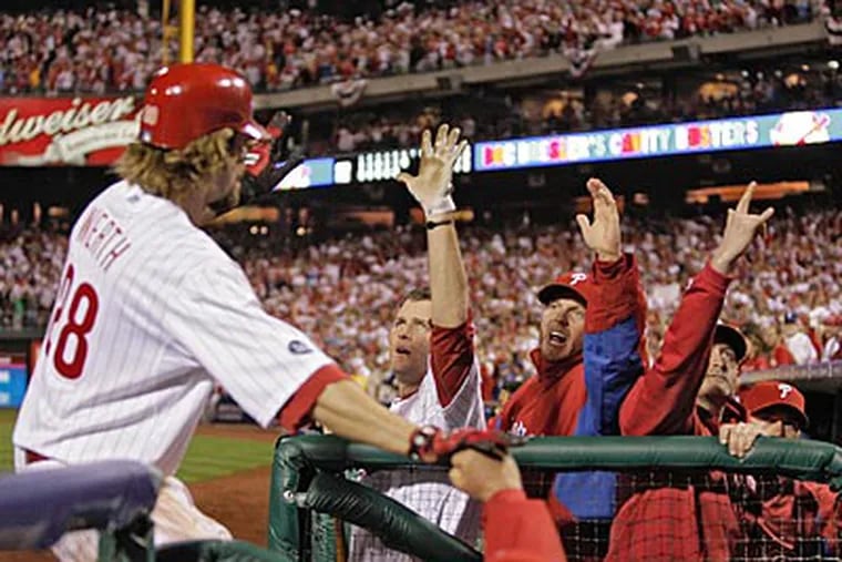 Jayson Werth is congratulated at the dugout after scoring the go-ahead run in the seventh inning. (Yong Kim/Staff Photographer)