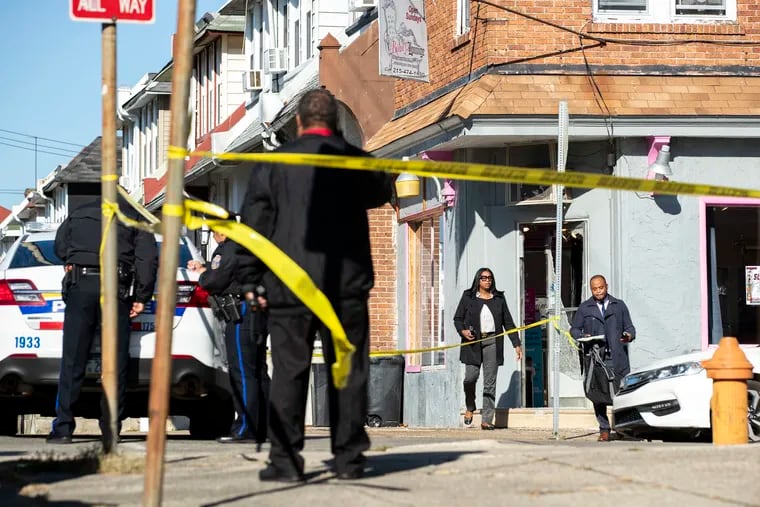 Investigation continues near the Beauty Lounge after a shooting at 60th and Oxford Streets in Philadelphia on Wednesday, Nov. 23, 2022. Officials noted that Overbrook High School got out at 11:30 a.m. on Wednesday and the shooting occurred shortly after. Multiple people were injured.