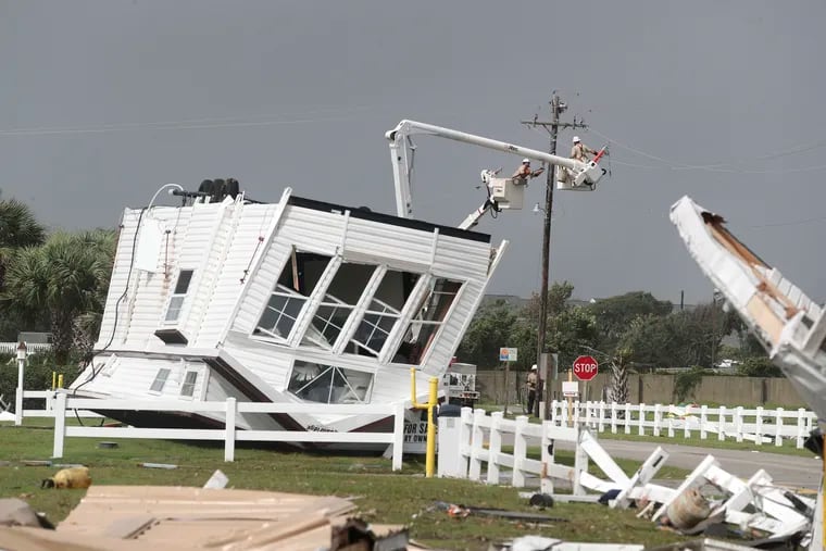 Power company lineman work to restore power after a tornado hit Emerald Isle N.C. as Hurricane Dorian moved up the East coast on Thursday, Sept. 5, 2018.