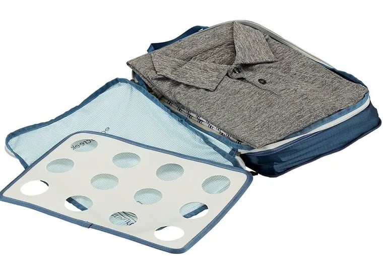 Eagle Creek Pack It Specter Tech Structured Compression Cube comes with a lightweight board for use in folding shirts.