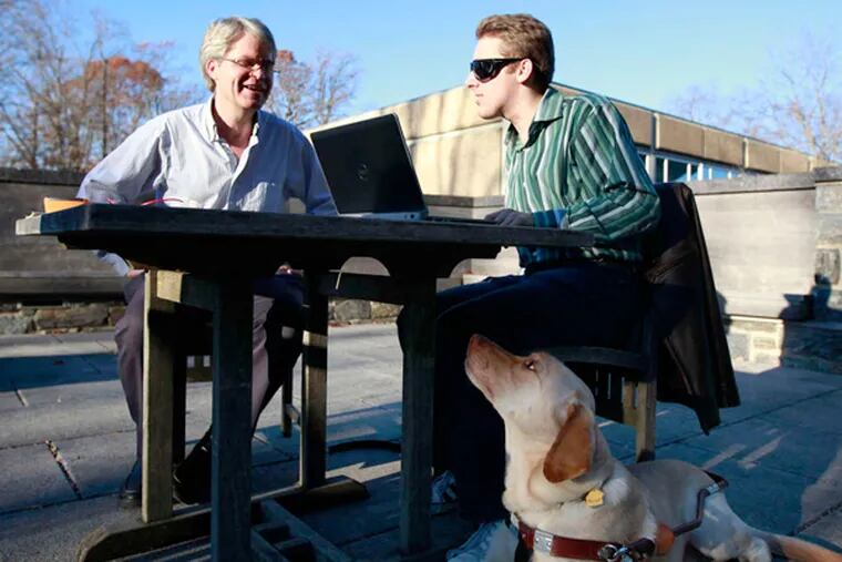 Swarthmore College engineering student Hayden Dahmm (right) of Springfield, Delaware County, with one of his professors, Carr Everbach, and guide dog, Fathom.
