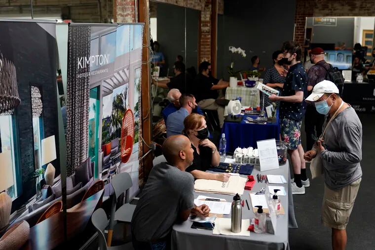 Prospective employers and job seekers interact during during a job fair on Sept. 22, 2021, in the West Hollywood section of Los Angeles.