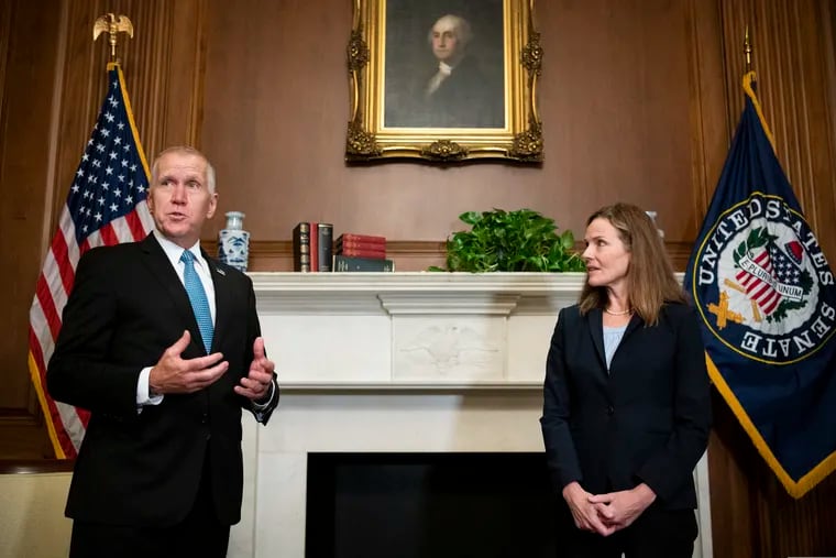 Sen. Thom Tillis, R-N.C. (left) meeting with Judge Amy Coney Barrett on Sept. 30. Tillis said Friday he tested positive for COVID-19.