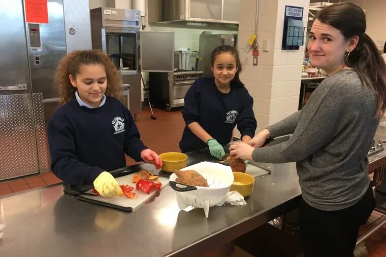 Amanda Segarra (left), Nyisha Amill, and teacher Jess Connelly prep vegetables at the after school cooking program at Feltonville School of the Arts in Kensington.