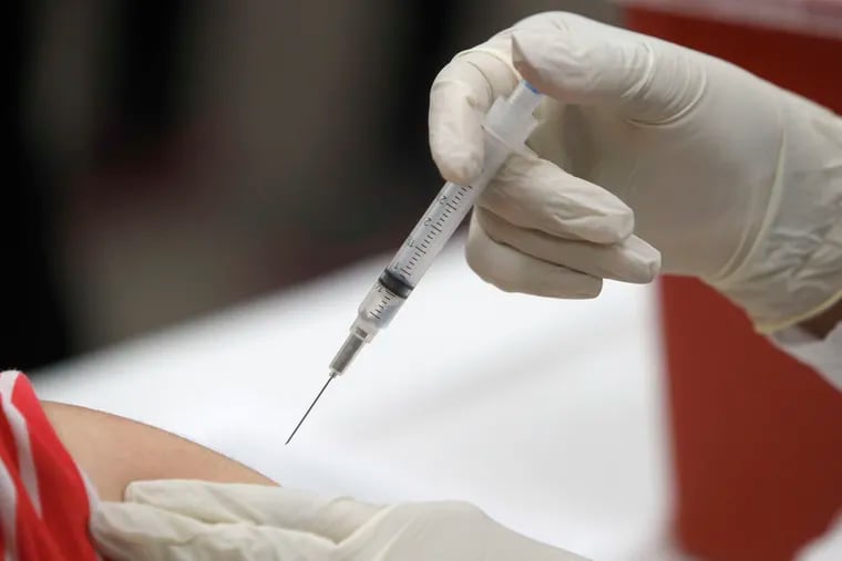 This Jan. 23, 2020 file photo shows a patient receiving a flu vaccination in Mesquite, Texas. The U.S. Centers for Disease Control and Prevention said the vaccine has been more than 50% effective in preventing flu illness severe enough to send a child to the doctor's office.