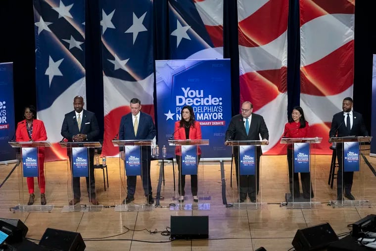 Top candidates for Philadelphia mayor stand during a debate at Temple University. From left: Cherelle Parker, Derek Green (who has since suspended his campaign), Jeff Brown, Rebecca Rhynhart, Allan Domb, Helen Gym, and Amen Brown.