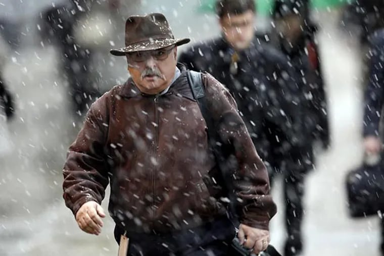 Commuters walk through a spring snowstorm Monday, March 25, 2013, in Philadelphia. The storm that blanketed the Midwest with heavy snow and slush continues its push east. (AP File Photo/Matt Rourke)