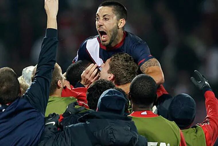 Clint Dempsey and the United States celebrated after their 1-1 draw with England on Saturday. (Elise Amendola/AP)