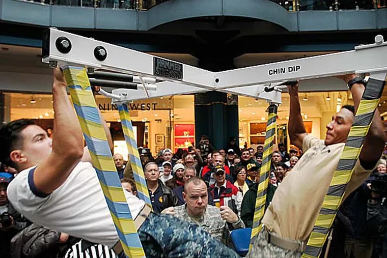 Army and Navy compete head to head in a pull up competition at Liberty Place during a pep rally. (Alejandro A. Alvarez/Staff Photographer)