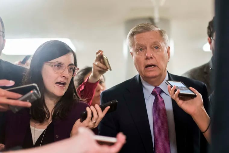 Sen. Lindsey Graham (R., S.C.) speaks to journalists while walking to the Senate floor in January.