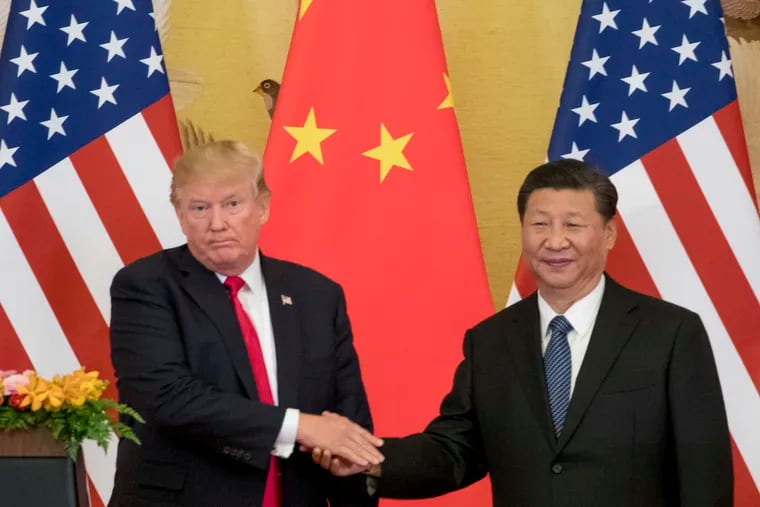 In this Nov. 9, 2017 file photo, President Donald Trump and Chinese President Xi Jinping shake hands during a joint statement in Beijing. The U.S. will impose a 25 percent tariff on $50 billion worth of Chinese goods containing "industrially significant technology."