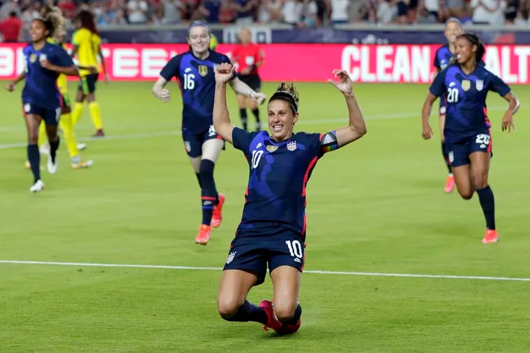 Carli Lloyd slides on the turf after scoring just 24 seconds into the United States' 4-0 win over Jamaica on Sunday in Houston.