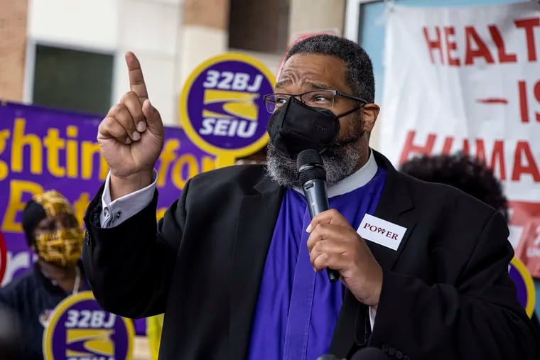 Bishop Dwayne Royster, executive director of POWER, speaks in front of frontline airport workers from SEIU Local 32BJ and the UNITE HERE Local 274 during a rally at the Philadelphia International Airport last month.