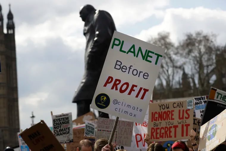 Climate change demonstrators hold banners in April in front of the Winston Churchill Statue during a protest near Parliament in London.