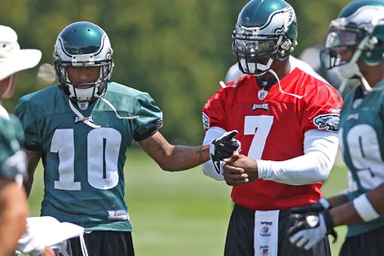 Philadelphia Eagles receiver DeSean Jackson (10) gives an encouraging hand bump to new teammate Michael Vick (7) during practice in Philadelphia, Pennsylvania, Saturday, August 15, 2009. (Michael Bryant / Staff Photographer)