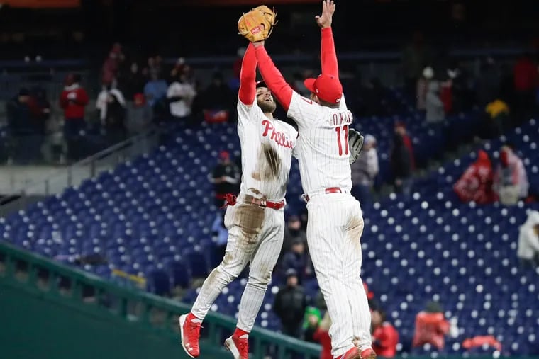 Phillies Bryce Harper and Rhys Hoskins celebrate the Phillies 10-6 win over the Minnesota Twins on Friday, April 5, 2019 in Philadelphia.