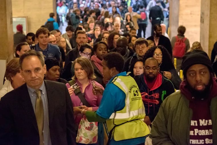 The line is long, extending out into the main concourse at 30th St. Station during the afternoon commute, as a SEPTA Ambassador checks passes and tickets on the first day of the SEPTA city workers’ strike on Tuesday.