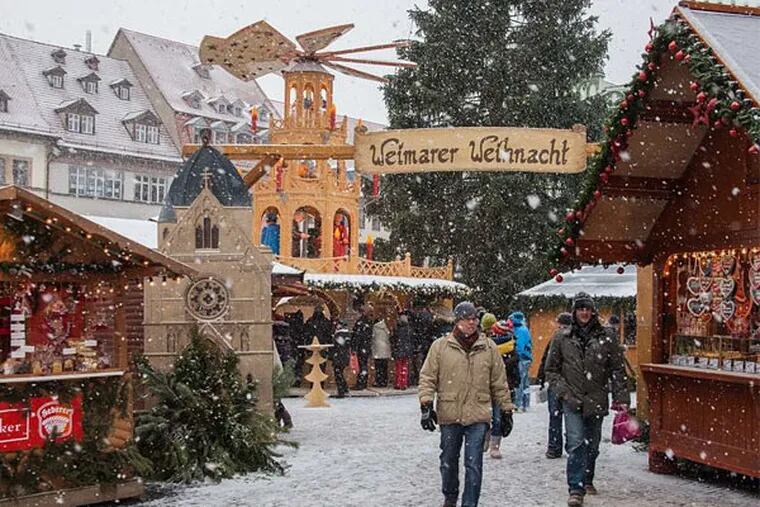 Snow falls on Weimar's colorful Christmas Market. Instead of deterring residents, the weather brings them out. (STEVE HAGGERTY / McClatchy Tribune News Service)