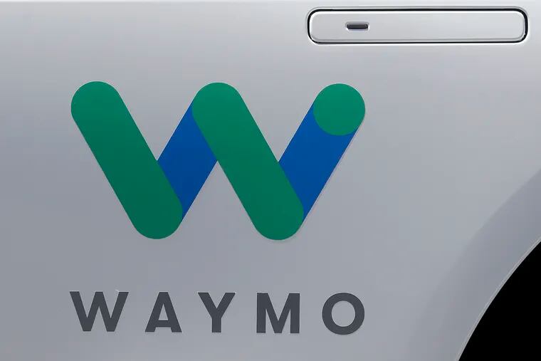 FILE - In this May 8, 2018, file photo, a Waymo logo is displayed on the door of a car at the Google I/O conference in Mountain View, Calif. Google's self-driving car spinoff Waymo is teaming up with Lyft in Arizona to attempt to lure passengers away from ride-hailing market leader Uber.