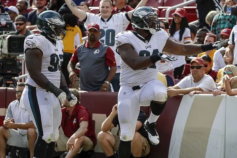 Eagles defensive tackle Fletcher Cox celebrates his touchdown fumble recovery with teammate Timmy Jernigan.