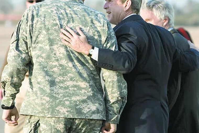 President Bush walks with Gen. Ray Odierno, commander of U.S. forces in Iraq, after arrivingin Baghdad for a surprise visit. Early today, Bush made a surprise stop in Afghanistan.