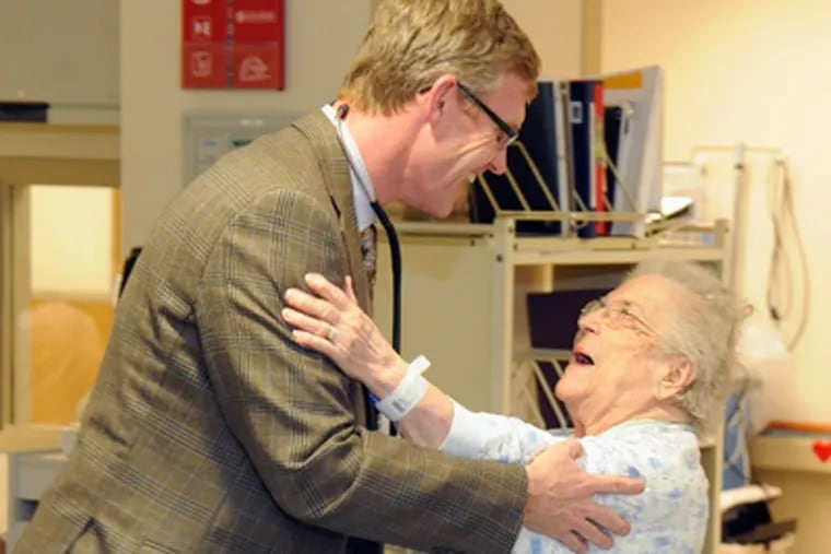 Cardiologist Reg Blaber greets Stella Dion, 93, of Haddonfield, at Our Lady of Lourdes, Camden. (Clem Murray / Staff Photographer)
