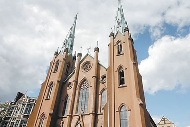 The Philadelphia Historic commission, which placed the ochre-colored Church of the Assumption on its historic register only last year, agreed to allow its demolition after the owner testified it was financially incapable of making crucial repairs to the green copper steeples. (Akira Suwa / Staff Photographer)
