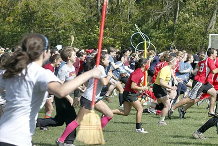 Quidditch tournament players rush to the other end of the field before the game. (Akira Suwa / Staff Photographer)