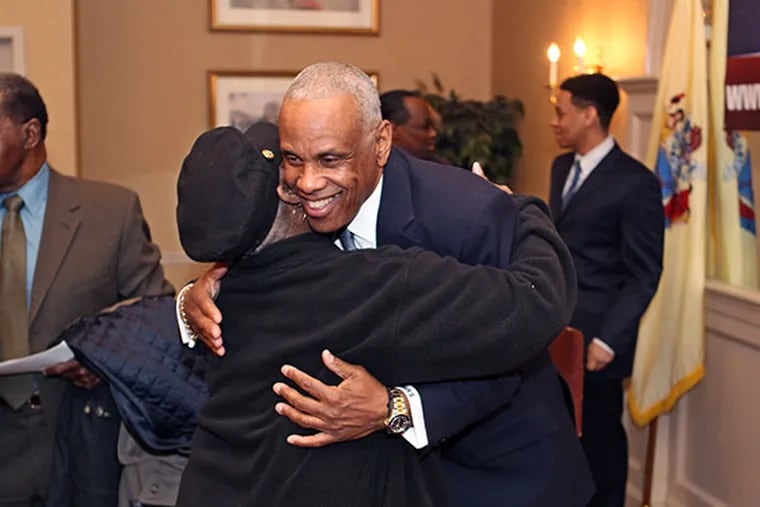 Logan Township Mayor Frank Minor, right, gets a big hug from Logan councilwoman Doris Hall after Minor's announcement that he was running for the First Congressional District seat in New Jersey on March 27, 2014. ( MICHAEL BRYANT / Staff Photographer )