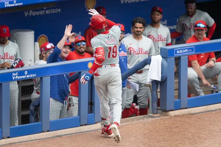 Phillies’ Cristian Pache is congratulated in the dugout by manager, Rob Thomson and teammates after a solo home run in sixth inning of the game against the Toronto Blue Jays on Thursday, Feb. 29, 2024, at TD Park in Dunedin, FL.