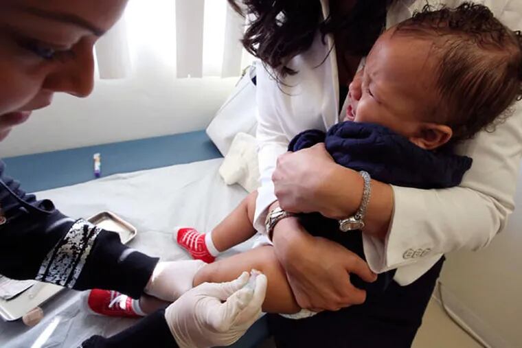 Medical assistant Daisi Minor, left, gives an MMR vaccine to Kristian Richard, 1, being held by his mother Natasha, at the Medical Arts Pediatric Med Group in Los Angeles on Feb. 6, 2015. (Mel Melcon/Los Angeles Times/TNS)
