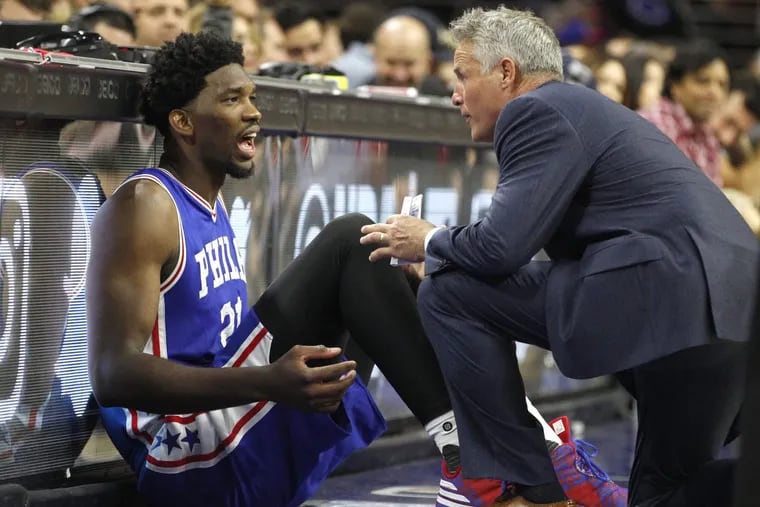 Sixers’ coach Brett Brown (right) has seen the Sixers through the dark days and out the other side.