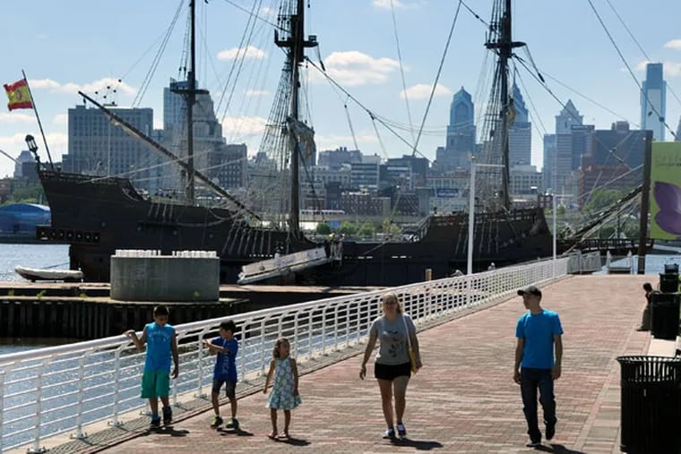 The Perdomo family, from Berks County, walks on the Camden waterfront June 24, 2015, after taking a preview look at the Spanish tall ship El Galeon the day before the Tall Ships Festival begins. (TOM GRALISH/Staff Photographer)