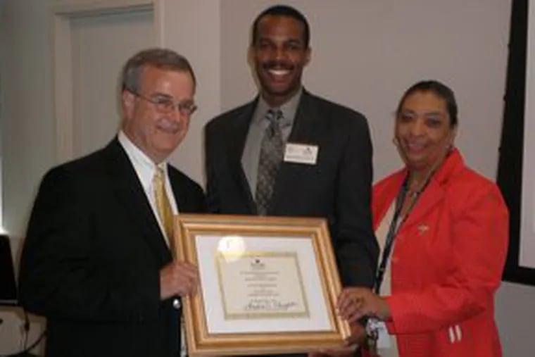 Michael Willmann (left) and Sandra Haughton (right) present Aubrey Fenton, Burlington County&#0039;s freeholder director, with the 2008 Community Partnership Award for the River Route project.