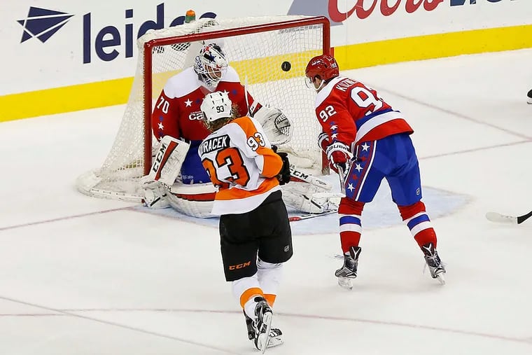Philadelphia Flyers right wing Jakub Voracek (93) scores a goal on Washington Capitals goalie Braden Holtby (70) as Capitals center Evgeny Kuznetsov (92) defends in overtime at Verizon Center. The Flyers won 4-3 in overtime.
