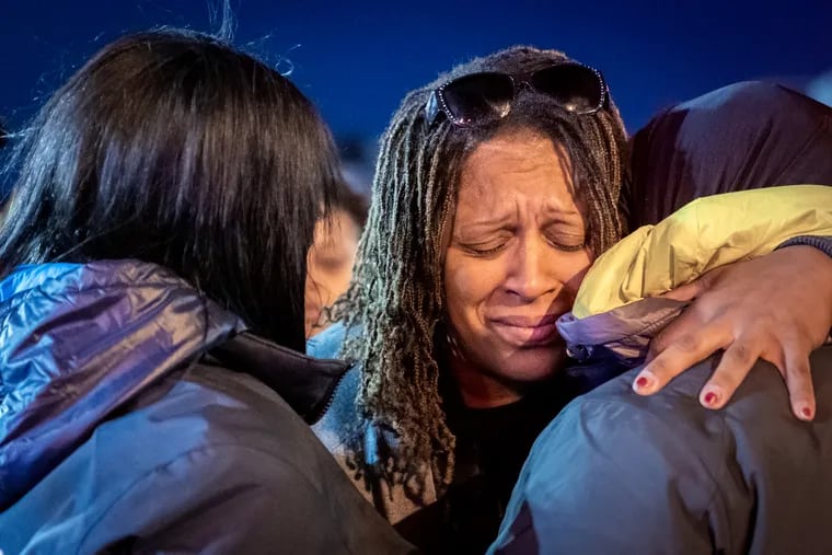 Roseann Morrison, center, is comforted by family members at a candlelight vigil for her daughter Sahmya Garcia on Nov. 14.