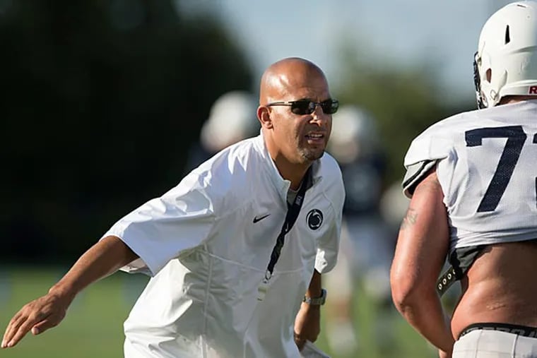 Penn State coach James Franklin encourages defensive tackle Brian Gaia during NCAA college football practice Thursday, Aug. 14, 2014, in State College, Pa. (AP Photo/PennLive.com, Joe Hermitt)