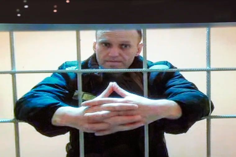 In this image provided by the Russian Federal Penitentiary Service, opposition leader Alexei Navalny appears on a video screen set up at Moscow City Court in May. Navalny said prison officials ordered him to serve at least three days in solitary confinement, citing a minor infraction, in retaliation for his activism behind bars.
