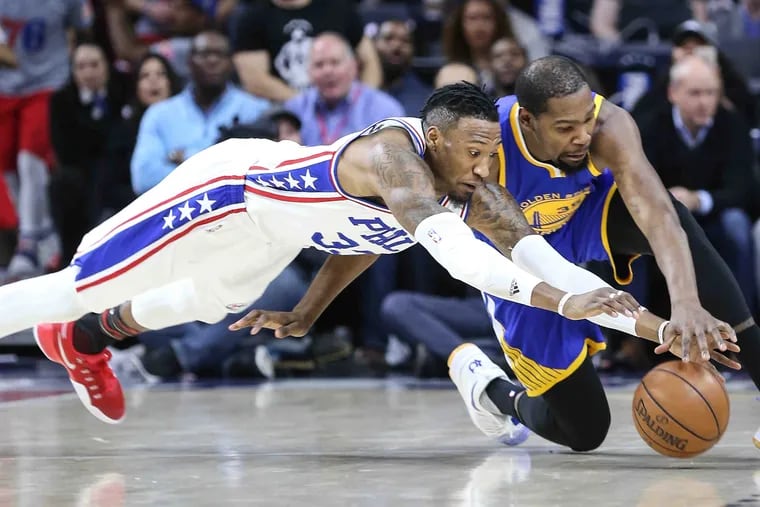 Robert Covington scrambles with Kevin Durant during a game against the Golden State Warriors in 2017.