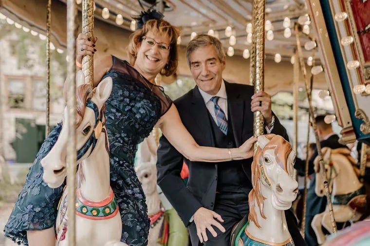 Newlyweds Laurie and Bert ride the Elmwood Park Zoo carousel.