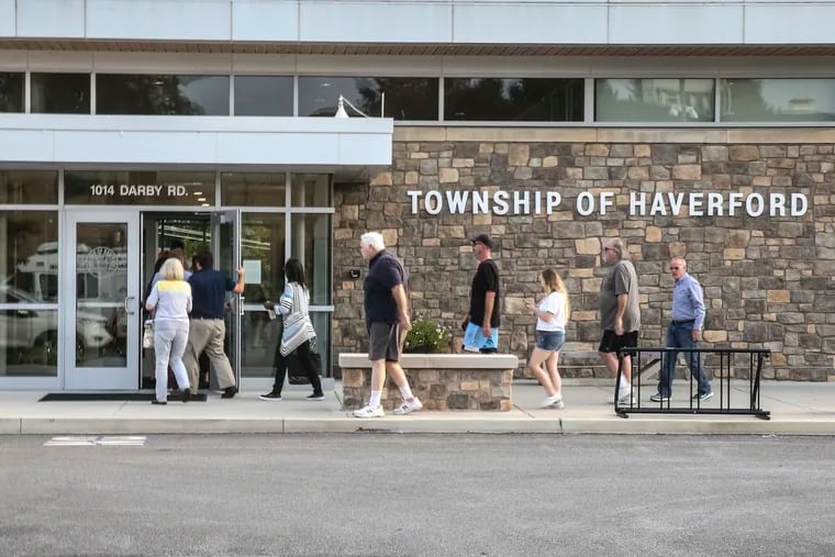 Residents head into a packed and angry meeting of the Haverford Township Board of Commissioners about stiff sanctions after a firefighter sought initiation into an extremist group.