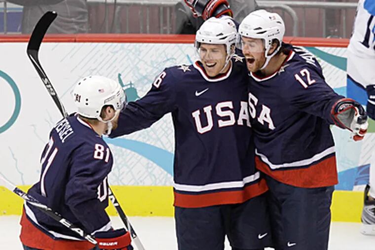 USA's Phil Kessel (81), Joe Pavelski (16), and Ryan Malone (12) celebrate a goal by Malone in the first period. (AP Photo/Julie Jacobson)