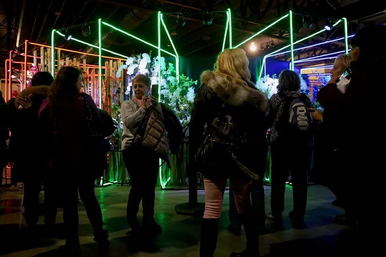 Crowds gather to photograph a display during the first day of the 2019 Philadelphia Flower Show. Thousands of attendees packed the show to see award-winning specimens and elaborate horticultural displays.